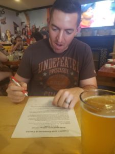 Ron Fartley signs the waiver at cazuelas for the mucho macho burrito challenge