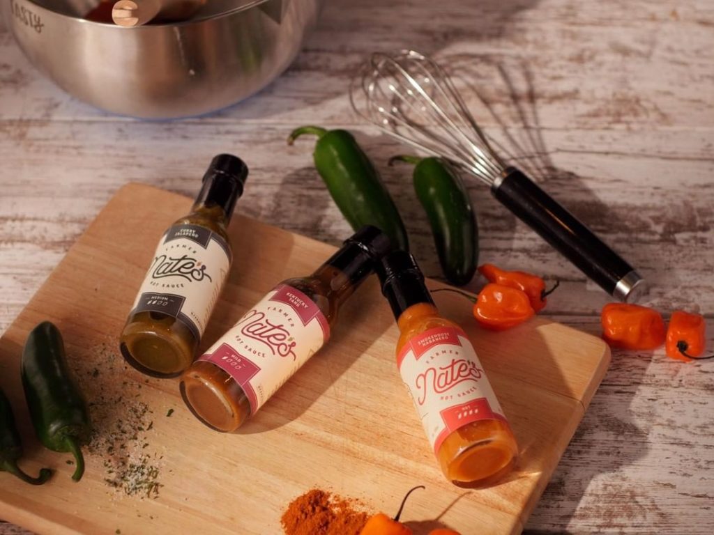 Craft hot sauce bottles with fresh peppers